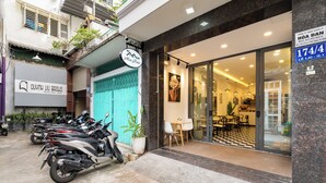 Un edificio con un letrero que dice "Quynh Lu Brows" y el número "174/4" que indica su dirección.