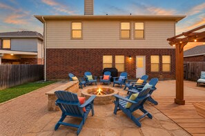 Inviting backyard patio with fire pit, grill, and cozy evening seating