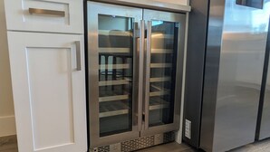 A stainless steel refrigerator with a freezer compartment, a built-in ice maker, and a water dispenser.