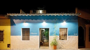 A building with a blue and white facade, a sign reading "CASA AMBERES," and a number "13-39" on the right. - Casa Amberes (Honda)