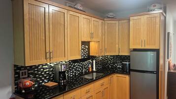 Fridge, microwave, coffee/tea maker, cookware/dishes/utensils