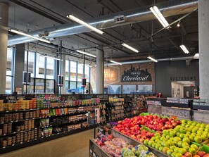 A grocery store interior with clear signage, including a 'Fairfax Cleveland' sign, and a variety of products on shelves.