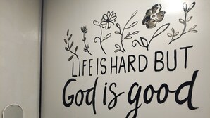 A wall with a motivational quote and decorative floral designs. - Semarang Co Stay (Semarang)