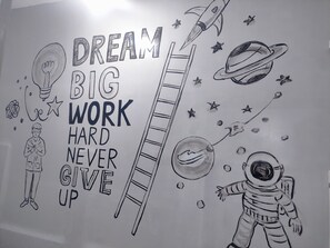 A hand-drawn inspirational poster with motivational phrases and space-themed drawings.