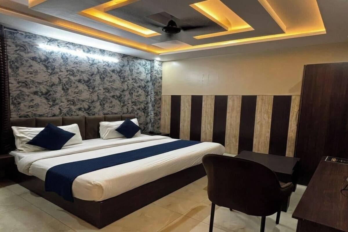 A modern bedroom with a bed, desk, and chair.