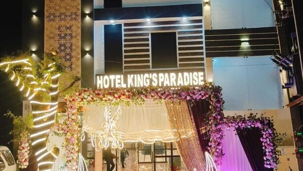 A hotel facade with a sign reading "HOTEL KING'S PARADISE." - Hotel Kings Paradise & Banquet (Lucknow)