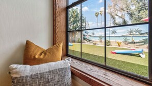 A room with a large window overlooking a tropical beach. - Pineapple Oasis - Private Heated Pool, Built-In BBQ, Game Room, ASU, Scottsdale (Tempe)