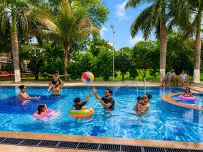 A swimming pool with people playing and relaxing. - The Elegance Resort (Chittorgarh)