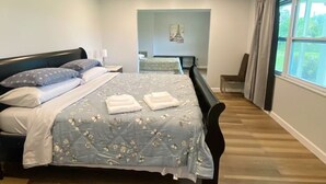 A bedroom with a bed, a desk, and a chair. - Peaceful and newly home with solar heated pool (Brandon)
