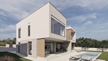 Una piscina al aire libre, sombrillas, sillones reclinables de piscina