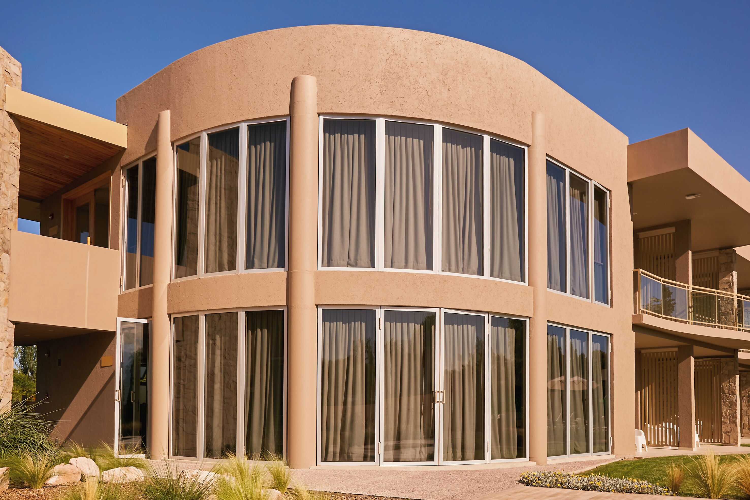 Un edificio moderno con ventanas amplias y una fachada curva.