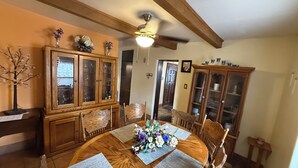 A dining room with a wooden table, chairs, and a cabinet. - Downtown, Old Town, Sawmill, 2-bedroom home in ABQ, additional parking available (Albuquerque)
