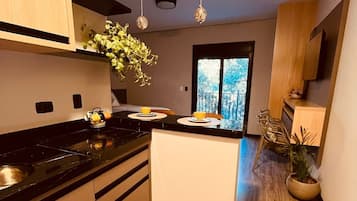 Fridge, microwave, coffee/tea maker, cookware/dishes/utensils