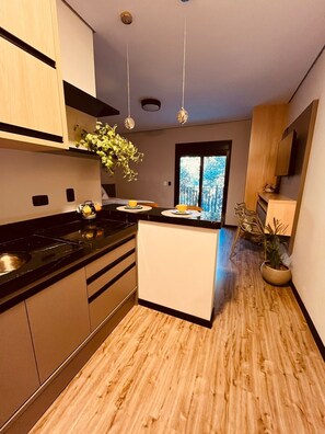 Fridge, microwave, coffee/tea maker, cookware/dishes/utensils