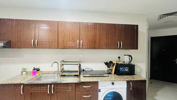 Fridge, microwave, electric kettle, cookware/dishes/utensils