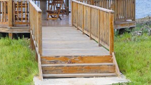 A wooden gazebo with a sloped roof, a wooden deck, and a railing. - Private Oasis - Portland’s Coastal Gated Hideaway (Fair Prospect)