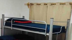 A bunk bed with two levels, metal frame, and blue bedding. - Cozy house near the beach (Mazatlan)