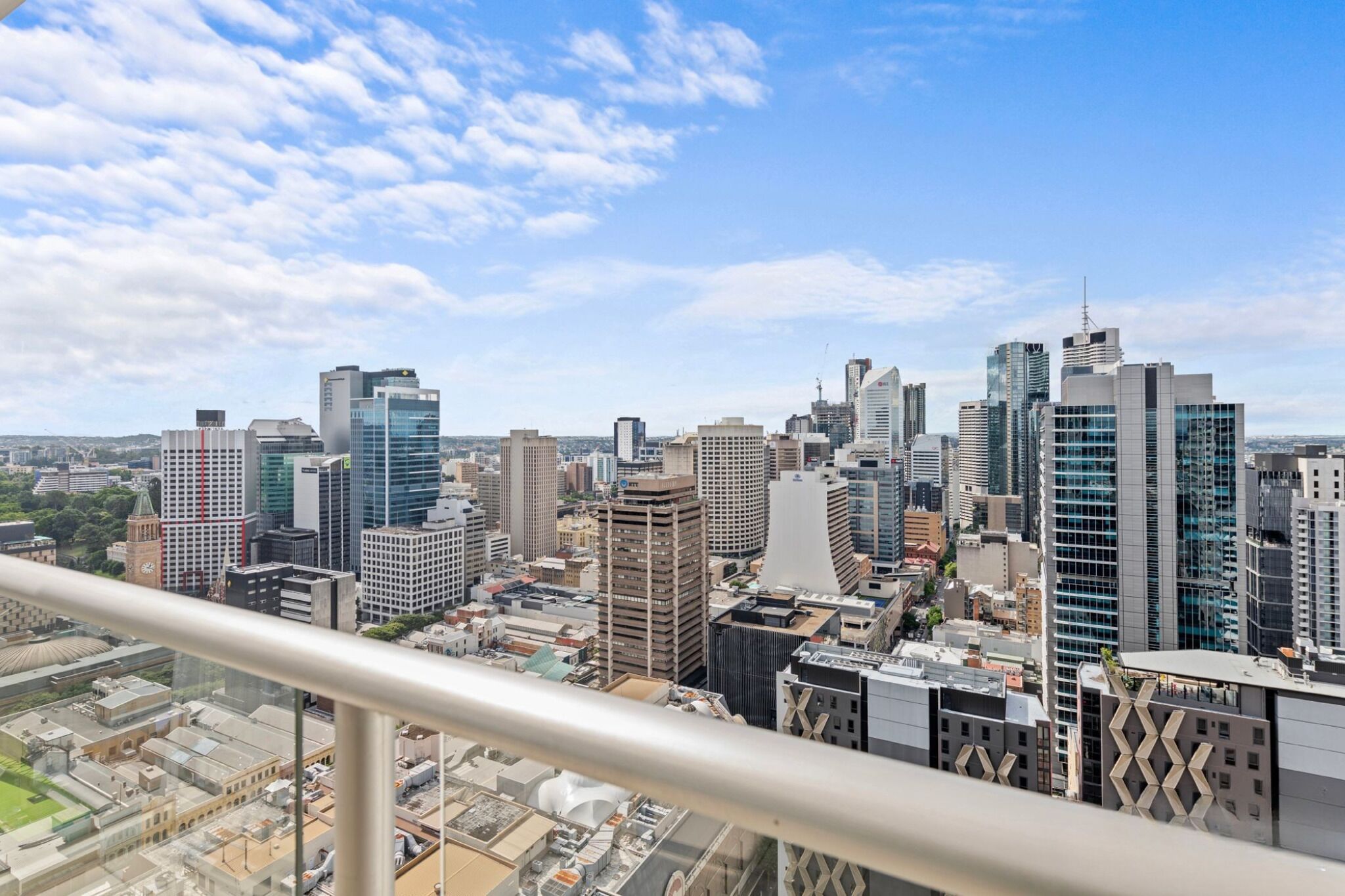 A cityscape with modern high-rise buildings and a clear sky.