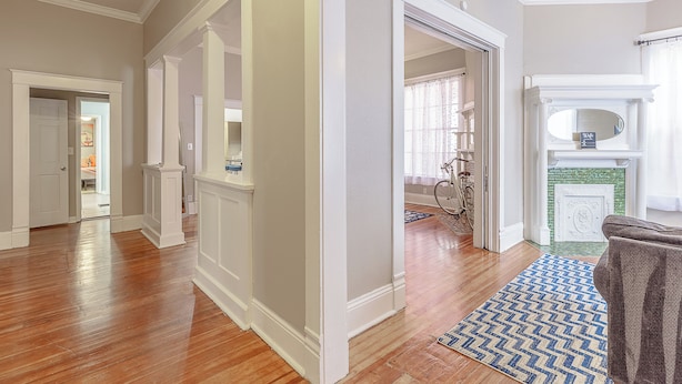 A spacious living room with hardwood floors, white walls, and a fireplace. - 3 King BedRooms Spacious & Serene House, Private Yard and Parking in Chattanooga (Chattanooga)