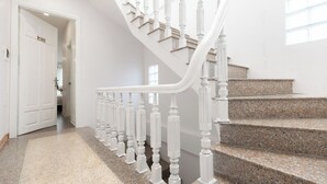 A white staircase with a curved handrail leading to a landing. - Better Home Hanoi (Hanoi)