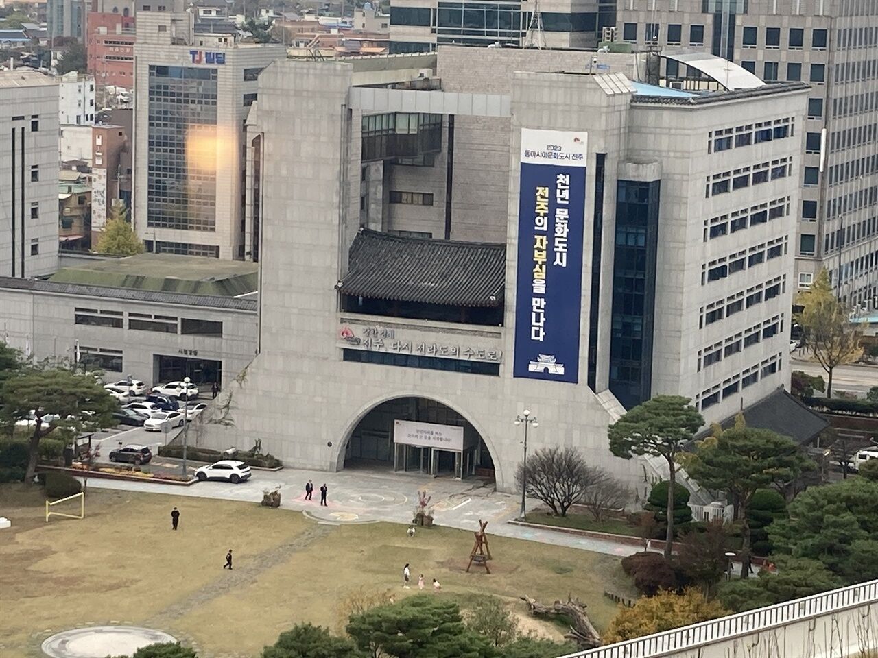 A large building with a prominent entrance and a flag.