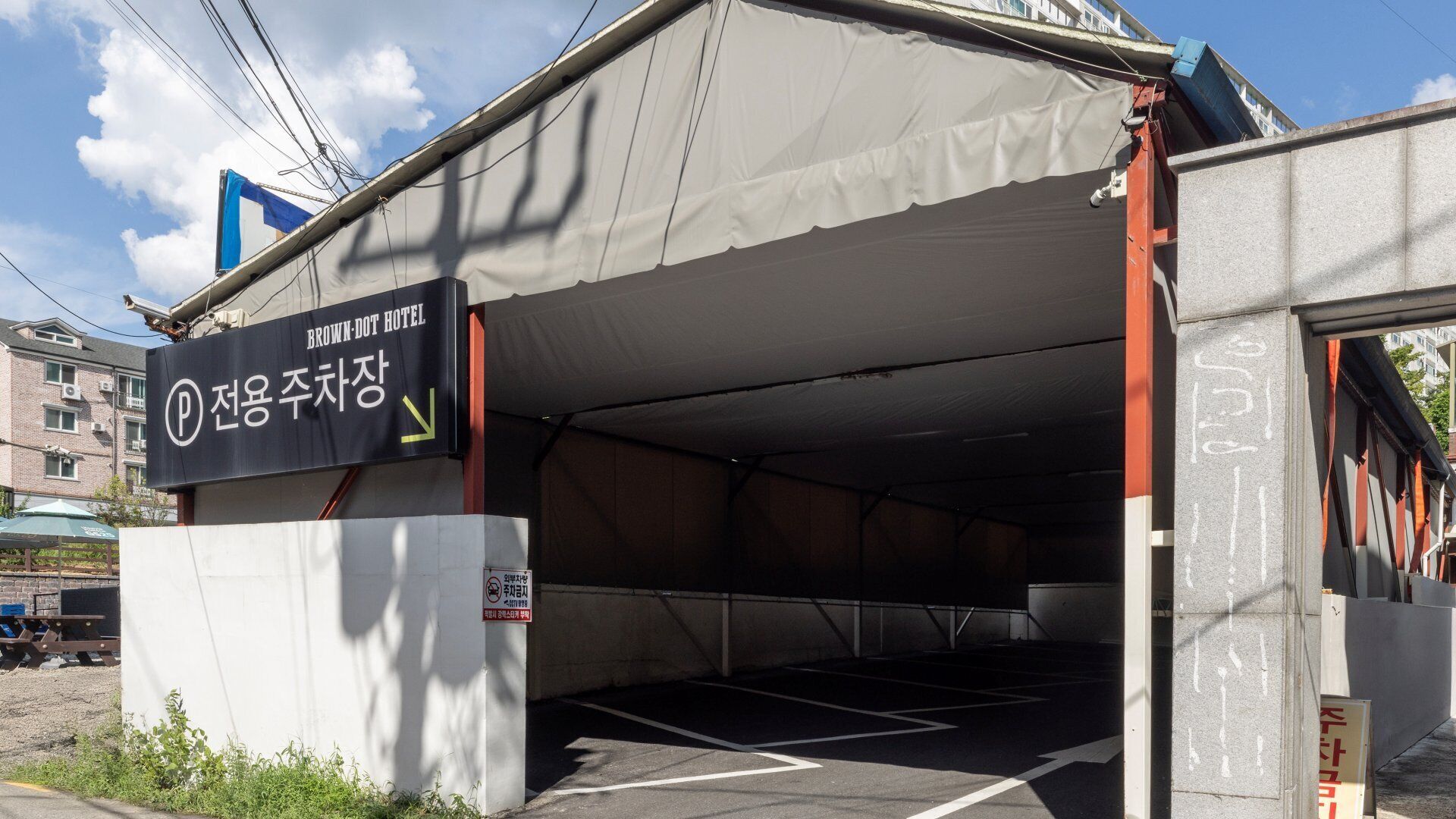 Einfahrt zu einer Parkgarage mit einem Schild für das Brown-Dot Hotel.