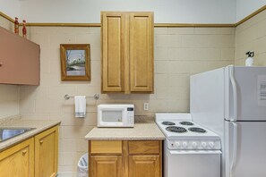 Fridge, microwave, coffee/tea maker, cookware/dishes/utensils