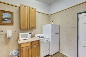 Fridge, microwave, coffee/tea maker, cookware/dishes/utensils
