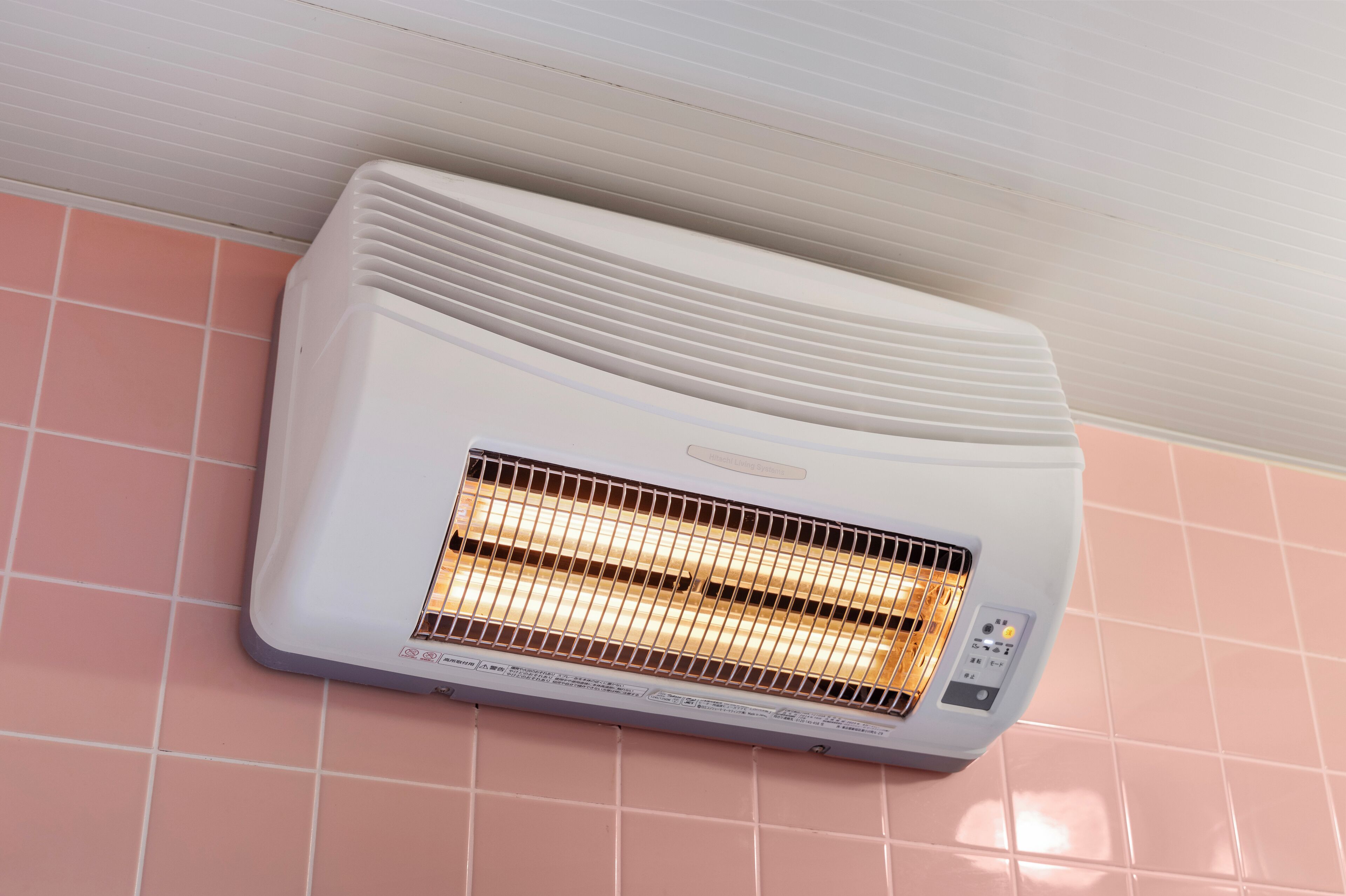 A wall-mounted air conditioner with a control panel and a visible heating element.