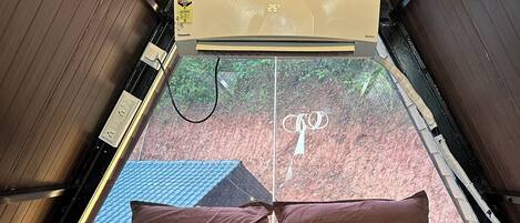 A room with a bed, a window, and a ceiling fan.