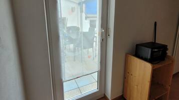 A door with a glass panel, a wooden cabinet, and a doormat with the word 'home' on it.