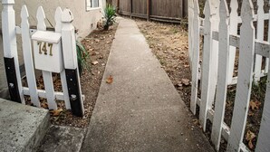 A residential driveway leading to a house with a mailbox marked '747'.