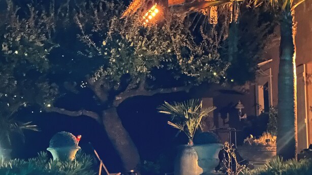 A nighttime view of a building with illuminated steps and surrounding greenery. - Family house - Country house - Holiday home (Grimaud)