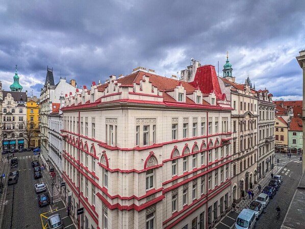 A multi-story building with a red and white facade, large windows, and a corner location.