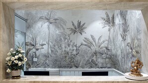 A reception area with a marble counter, a potted plant, and a statue. - TreeHouse Velis Sonipat (Ganaur)