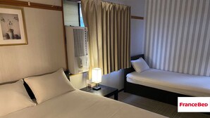 A hotel room with a large bed, a smaller bed, a nightstand with a lamp, a window with curtains, and a framed picture on the wall. - The whole building can be rented (only for guests) Long term welcome Outlet 7 min walk 11 people 1 bedding per person, no hassle Max 12 people, clean, spacious with Japanese style rooms 4 free parking spaces 4 bedrooms BBQ reservations possible (木更津市)