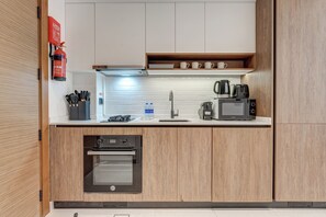 Exclusive Studio, Balcony, Pool View | Private kitchen | Full-size fridge, microwave, oven, stovetop