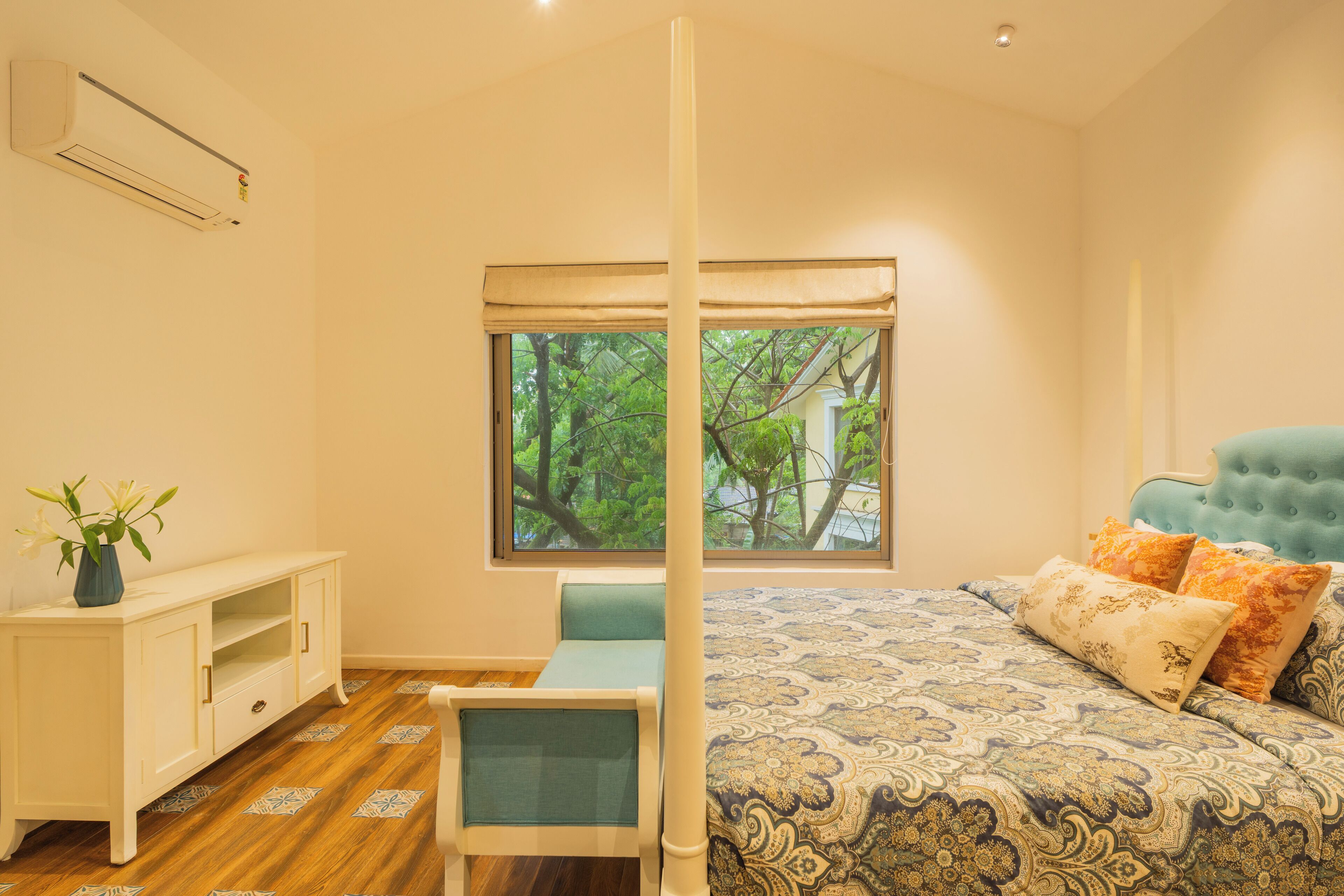 Un dormitorio con cama, ventana, mesita de noche y una silla.
