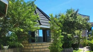 A house with a stone facade, a tiled roof, and a pathway leading to the entrance. - Oleng'oti Gardens Narok (Narok)