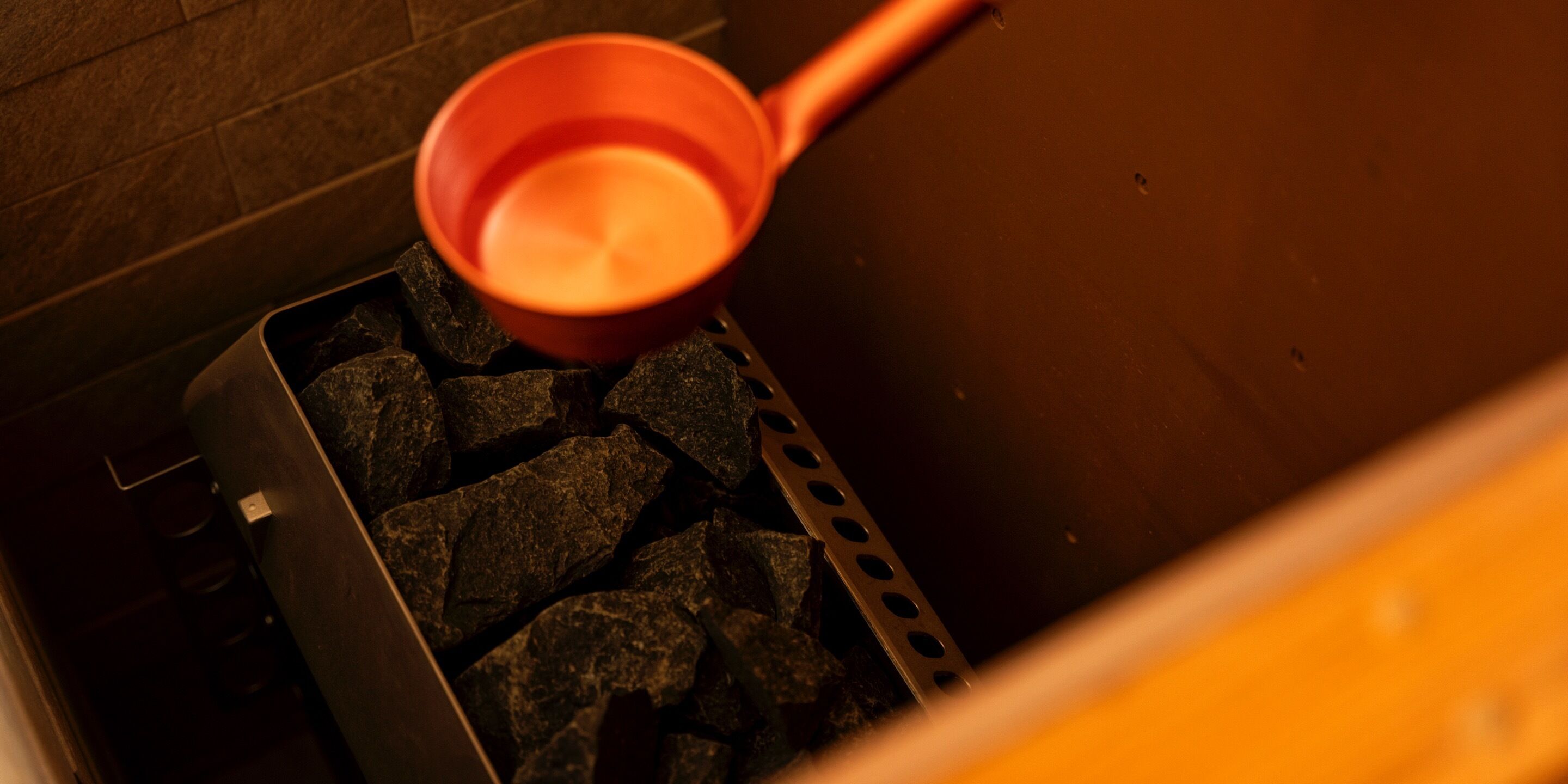 A metal container filled with charcoal pieces.