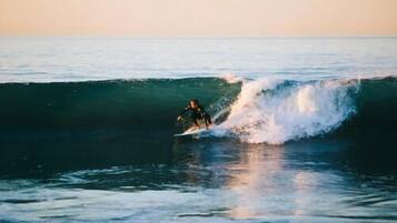 A surfer riding a wave in the ocean.