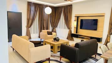 Deluxe Suite, 3 Bedrooms, Housekeeping, Hill View | Living area | 32-inch Smart TV with digital channels