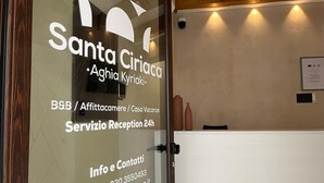 A reception area with a glass door displaying the name 'Santa Ciriaca' and contact information. - Santa Ciriaca - Aghìa Kyriaki (Gerace)