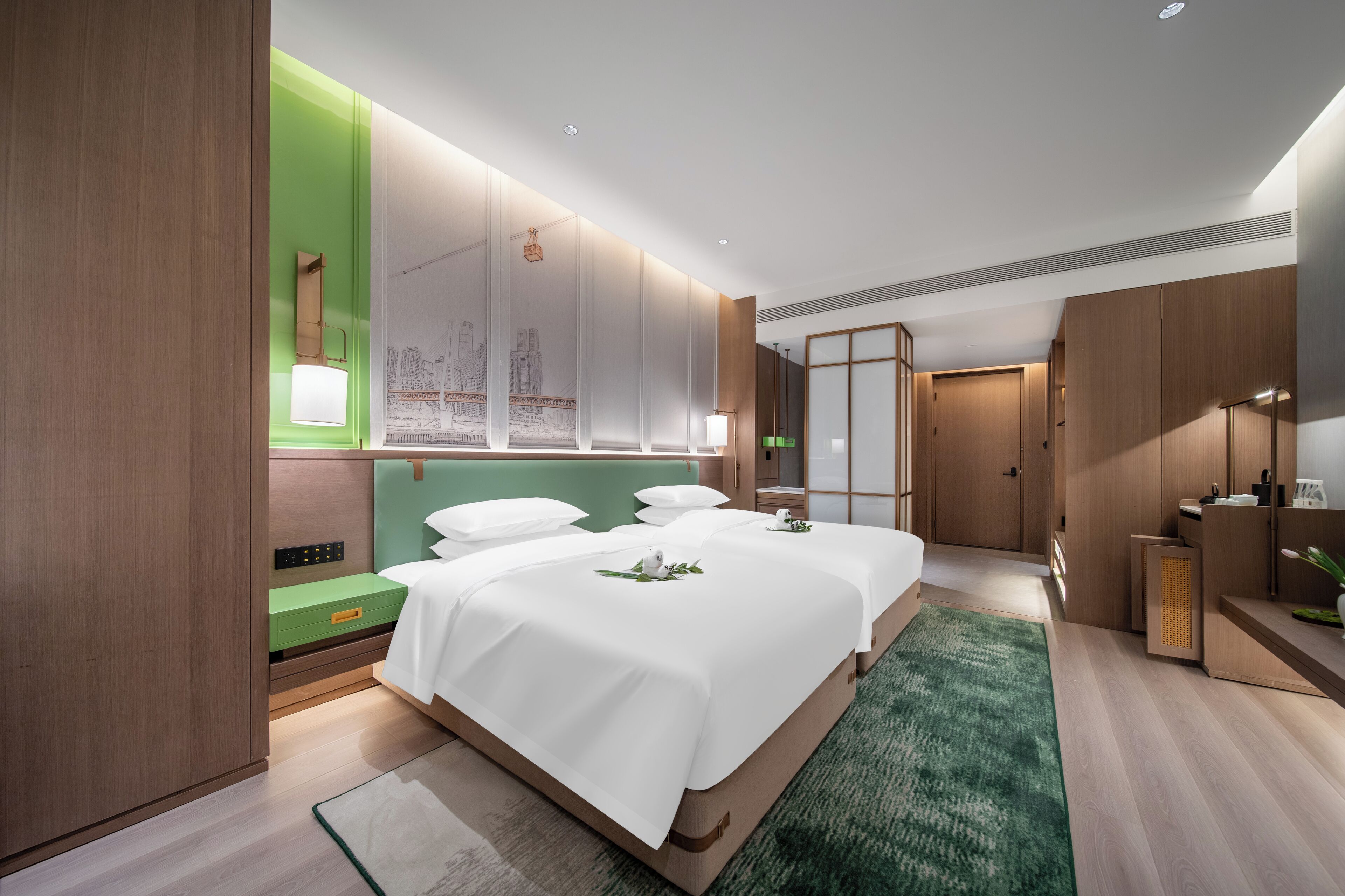 A modern hotel room with two beds, a green accent wall, a large window, and a separate bathroom area.