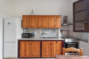 Fridge, microwave, coffee/tea maker, cookware/dishes/utensils
