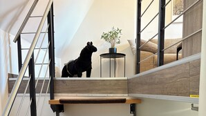 A modern staircase with wooden steps and metal railings.