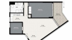 A floor plan of a 2-bedroom apartment with a balcony, kitchen, dining area, and a combined living and bedroom space. - The Sands Beachfront city centre (Surfers Paradise)