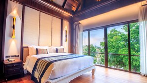 A large bed with a white and blue striped blanket, a wooden nightstand with a phone, and a large window with a view of trees. - S48 River Ping Hotel (Chiang Mai)