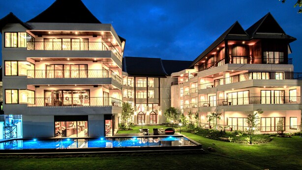 A multi-story hotel with a swimming pool and outdoor seating area. - S48 River Ping Hotel (Chiang Mai)