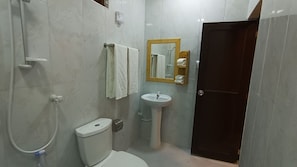 Shower, hair dryer, slippers, towels